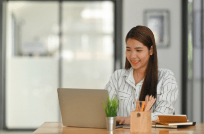 Woman smiling at laptop computer