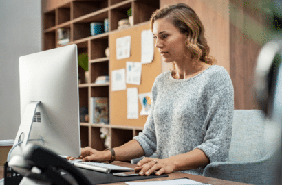 Woman working in office looking at computer monitor